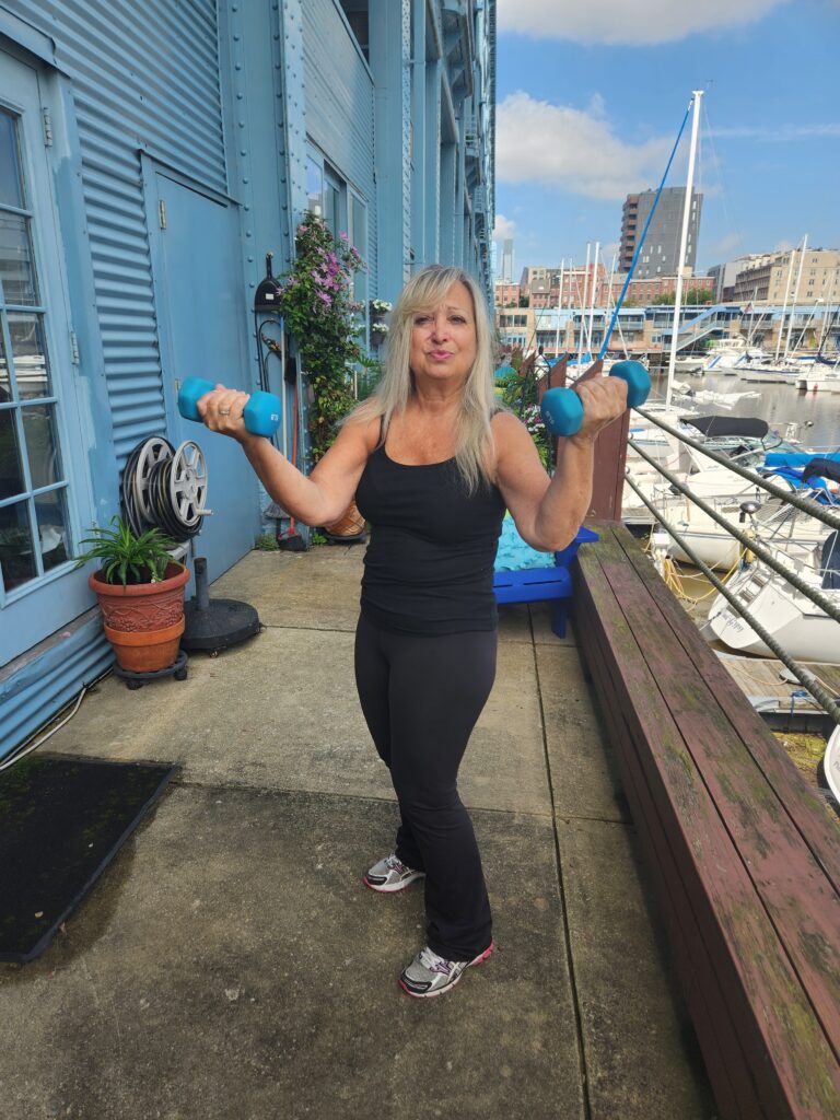 after picture of middle aged woman with blonde hair holding weights | Smart Moves Fitness online personal trainer
